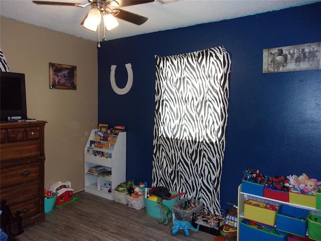 recreation room featuring ceiling fan and wood finished floors