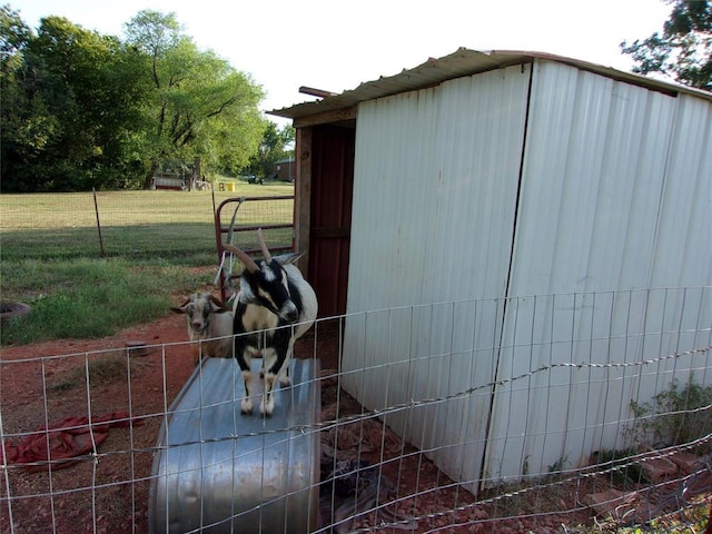 view of outbuilding featuring fence