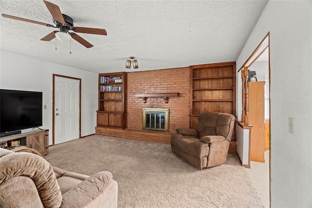 living room with a fireplace, ceiling fan, light carpet, and a textured ceiling