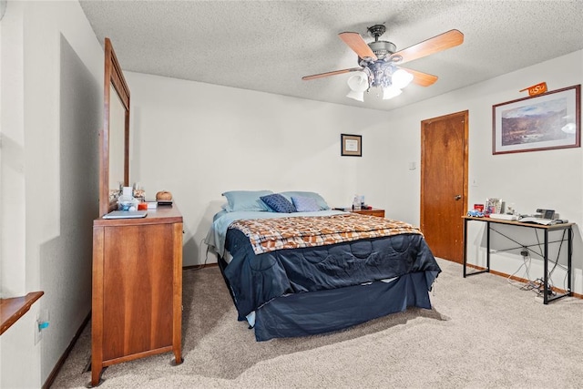bedroom featuring carpet floors, a textured ceiling, ceiling fan, and baseboards