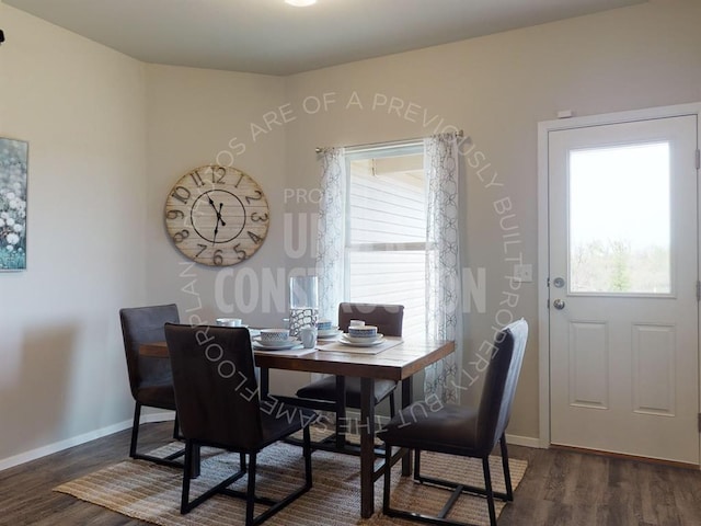 dining space featuring baseboards, a wealth of natural light, and dark wood-type flooring