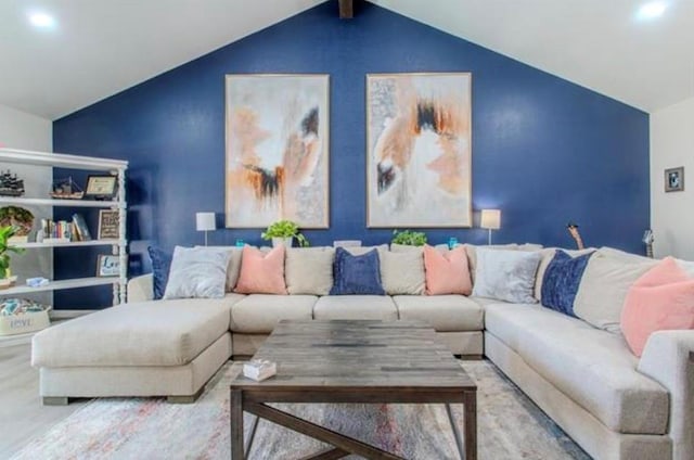 living area with wood finished floors and lofted ceiling
