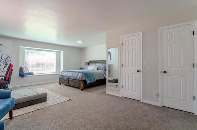 bedroom featuring carpet floors and baseboards