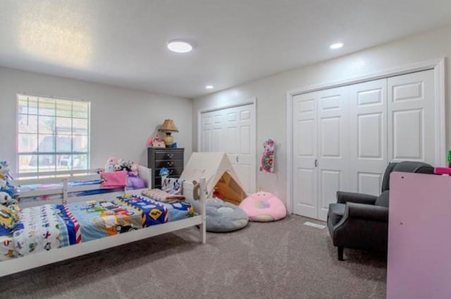 bedroom with carpet flooring, recessed lighting, and two closets