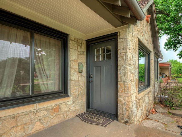 doorway to property with stone siding