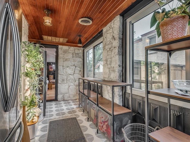 sunroom / solarium featuring visible vents and wooden ceiling