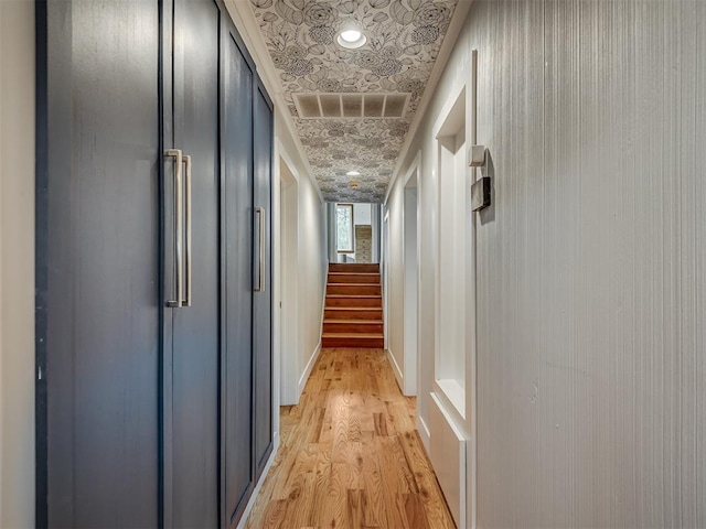 corridor featuring an ornate ceiling, visible vents, stairs, and light wood-style floors