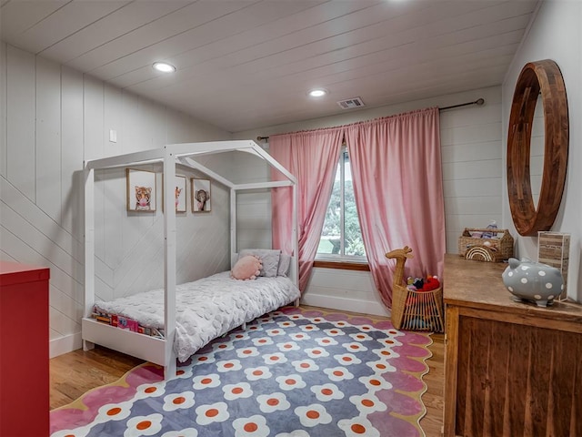 bedroom featuring recessed lighting, wood finished floors, and visible vents