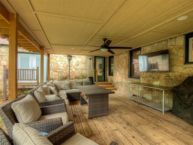 deck with outdoor lounge area and a ceiling fan