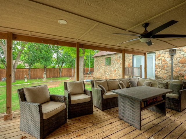 sunroom / solarium featuring a ceiling fan and an outdoor living space