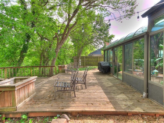 wooden deck with fence and a grill
