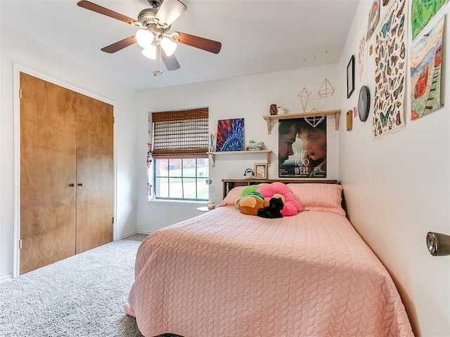 carpeted bedroom with a closet, baseboards, and a ceiling fan