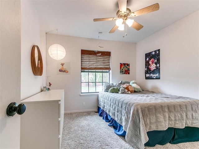 bedroom featuring a ceiling fan, baseboards, and light colored carpet