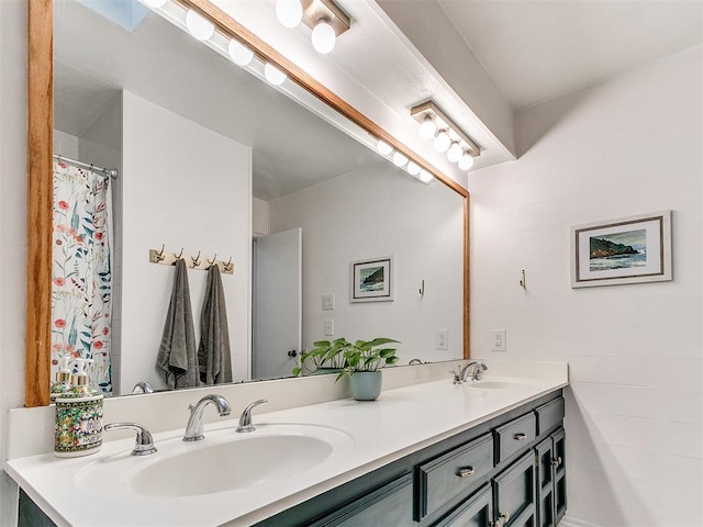 full bath with a sink and double vanity