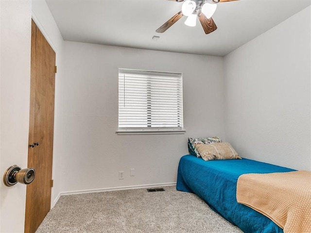bedroom with carpet floors, baseboards, ceiling fan, and visible vents