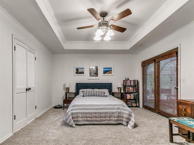 bedroom featuring carpet flooring, a raised ceiling, and ornamental molding
