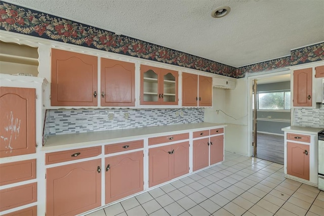 kitchen with light countertops, a textured ceiling, and decorative backsplash