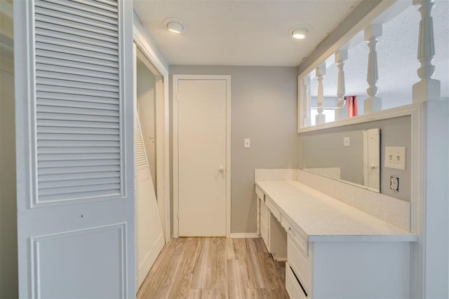 interior space featuring light wood-type flooring and baseboards