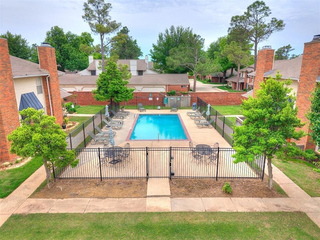 pool with fence and a residential view