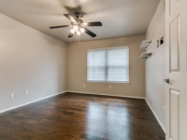 unfurnished room featuring baseboards, a ceiling fan, and wood finished floors