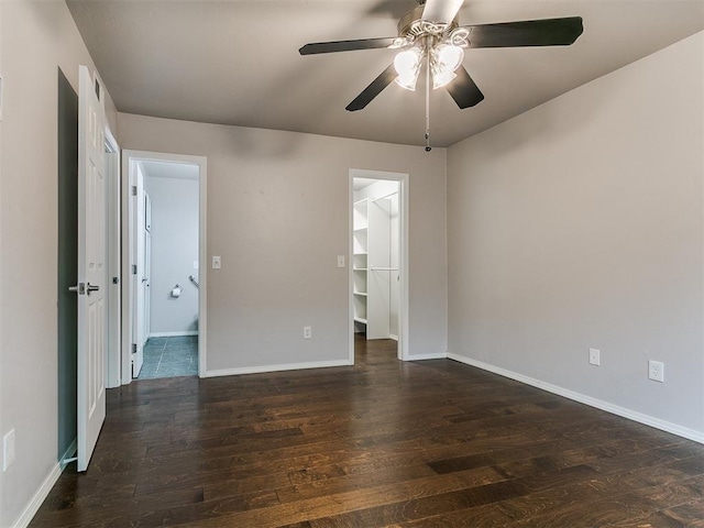 spare room with baseboards, a ceiling fan, and hardwood / wood-style floors
