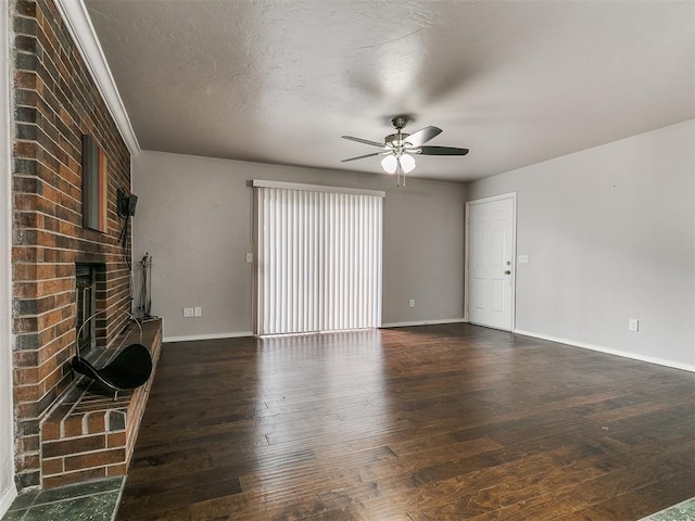 unfurnished living room featuring baseboards, dark wood-type flooring, and a ceiling fan