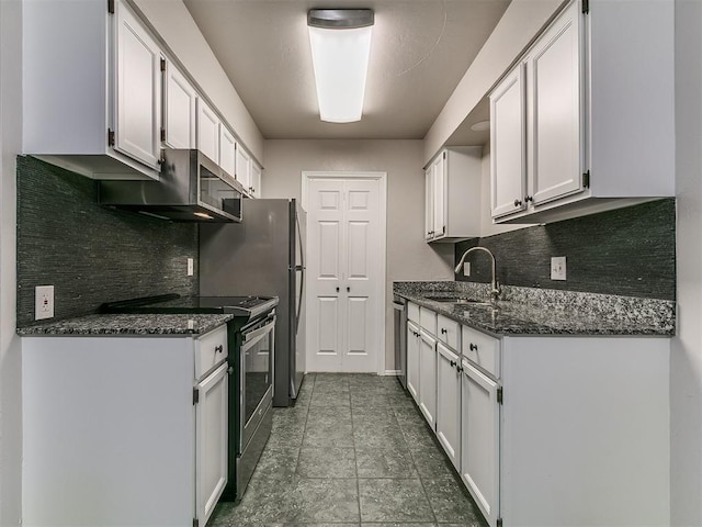 kitchen with a sink, white cabinetry, backsplash, dark stone counters, and appliances with stainless steel finishes