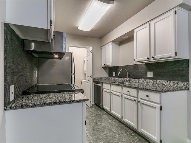kitchen featuring dark stone counters, dishwasher, a sink, and backsplash