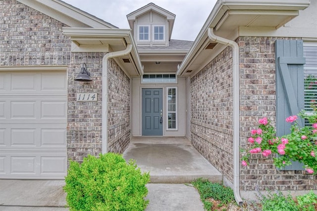 1114 Old Frisco Rd, Norman, OK 73069 - doorway to property with an attached garage and brick siding