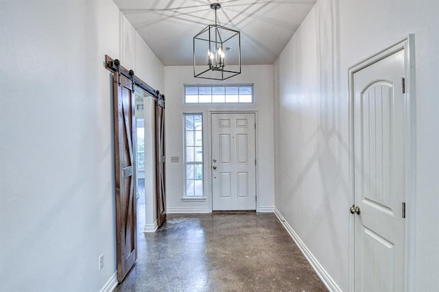 1114 Old Frisco Rd, Norman, OK 73069 - entryway with an inviting chandelier, a barn door, finished concrete floors, and a wealth of natural light