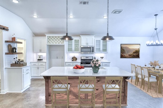 1114 Old Frisco Rd, Norman, OK 73069 - kitchen featuring backsplash, stainless steel appliances, open shelves, and visible vents