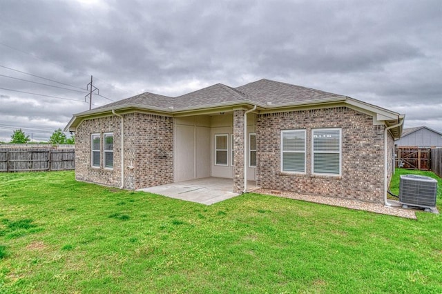 1114 Old Frisco Rd, Norman, OK 73069 - rear view of property with roof with shingles, a lawn, brick siding, cooling unit, and a fenced backyard