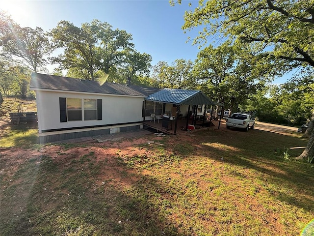 rear view of property featuring a yard