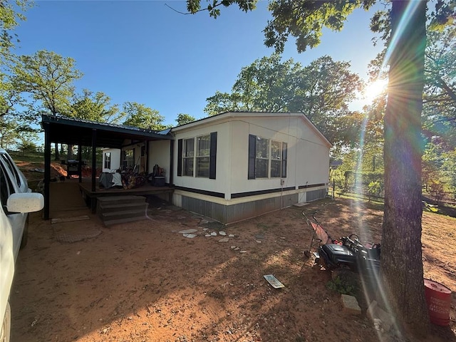 view of side of property featuring a wooden deck