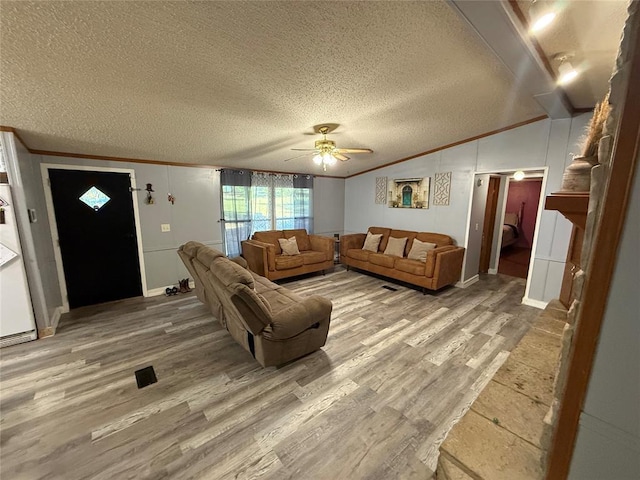 living room with ornamental molding, a textured ceiling, and wood finished floors