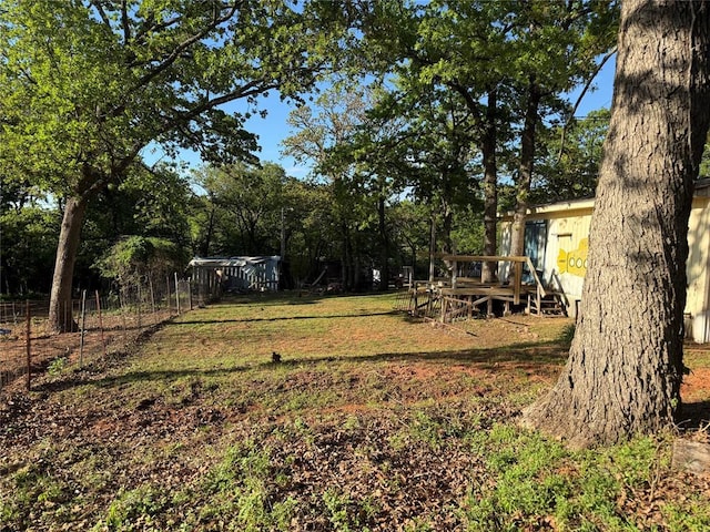 view of yard with fence and a wooden deck
