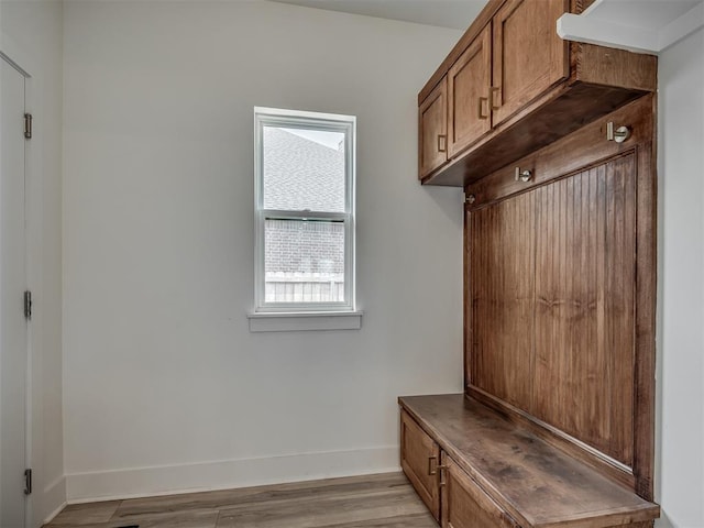 mudroom featuring baseboards and light wood finished floors