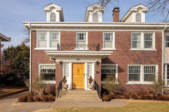 201 NW 18th St, Oklahoma City, OK 73103 - view of front of home with a balcony, a chimney, and brick siding