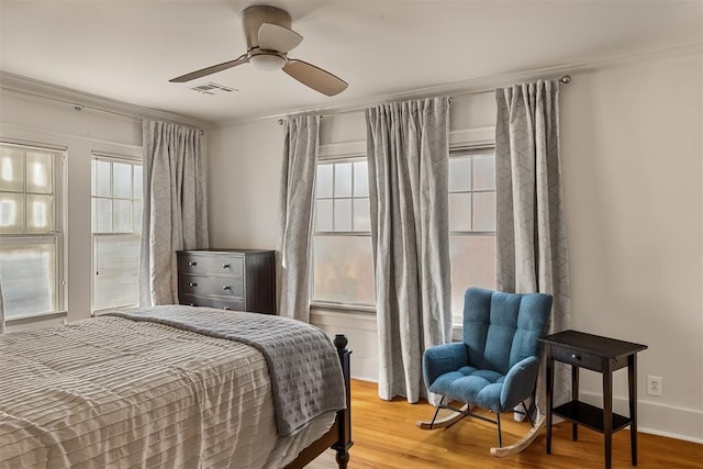 201 NW 18th St, Oklahoma City, OK 73103 - bedroom with visible vents, ornamental molding, wood finished floors, and multiple windows