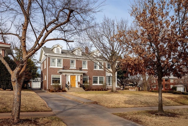 201 NW 18th St, Oklahoma City, OK 73103 - view of front facade with brick siding, a garage, a chimney, and aphalt driveway