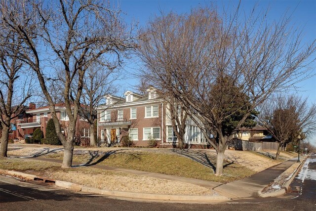 201 NW 18th St, Oklahoma City, OK 73103 - view of front of property featuring fence, a front lawn, and brick siding
