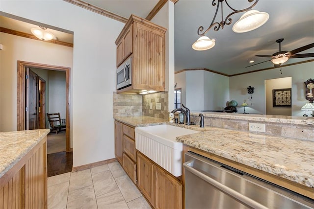 10608 Oaksplinter Ln, Oklahoma City, OK 73173 - kitchen with a ceiling fan, crown molding, a sink, light stone counters, and stainless steel appliances