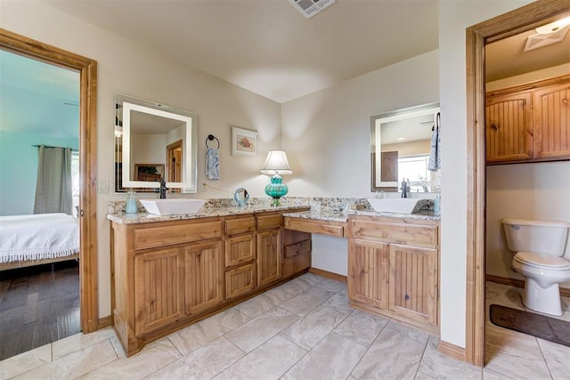 10608 Oaksplinter Ln, Oklahoma City, OK 73173 - ensuite bathroom with vanity, toilet, ensuite bath, and visible vents