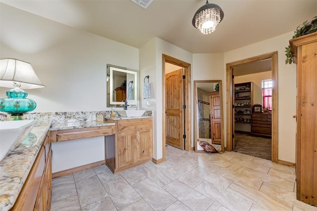 10608 Oaksplinter Ln, Oklahoma City, OK 73173 - bathroom featuring a chandelier, a walk in closet, and vanity