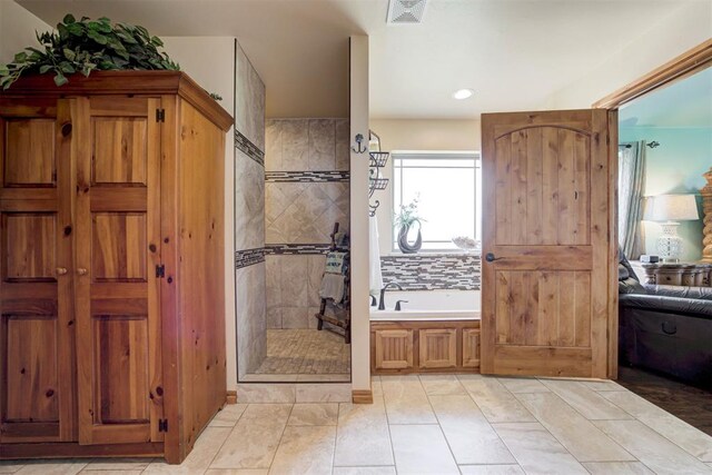 10608 Oaksplinter Ln, Oklahoma City, OK 73173 - bathroom featuring visible vents, recessed lighting, walk in shower, and a garden tub