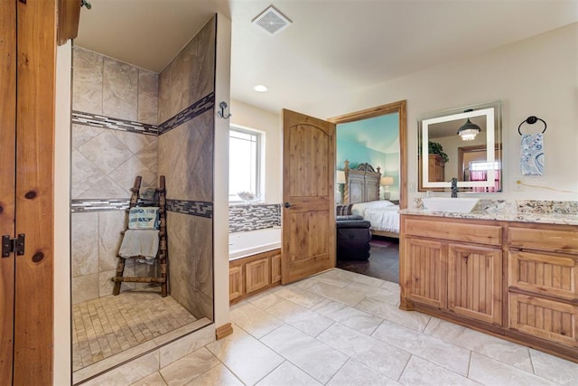 10608 Oaksplinter Ln, Oklahoma City, OK 73173 - bathroom with connected bathroom, a walk in shower, vanity, visible vents, and a garden tub