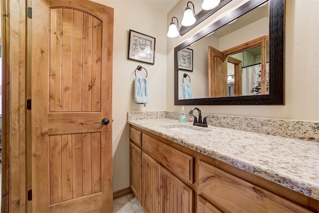 10608 Oaksplinter Ln, Oklahoma City, OK 73173 - bathroom featuring baseboards, tile patterned flooring, and vanity