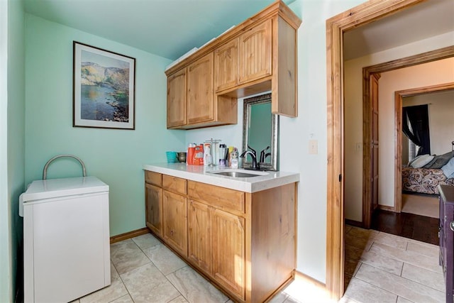 10608 Oaksplinter Ln, Oklahoma City, OK 73173 - kitchen with baseboards, a sink, and light countertops
