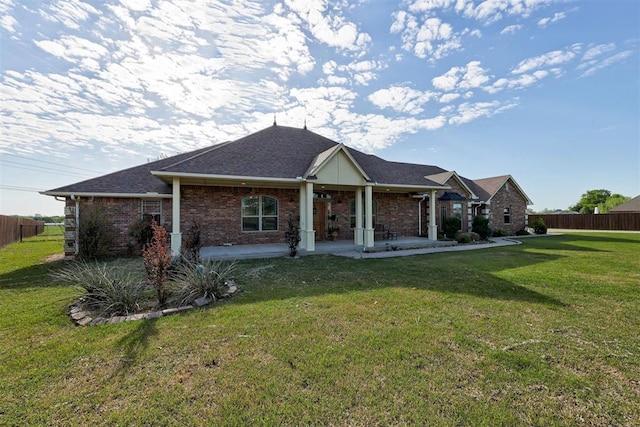 10608 Oaksplinter Ln, Oklahoma City, OK 73173 - back of property featuring fence, a shingled roof, a yard, and brick siding