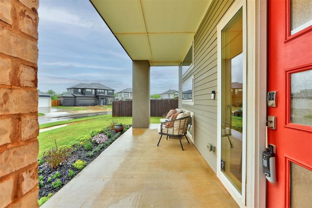 view of patio with fence and a residential view